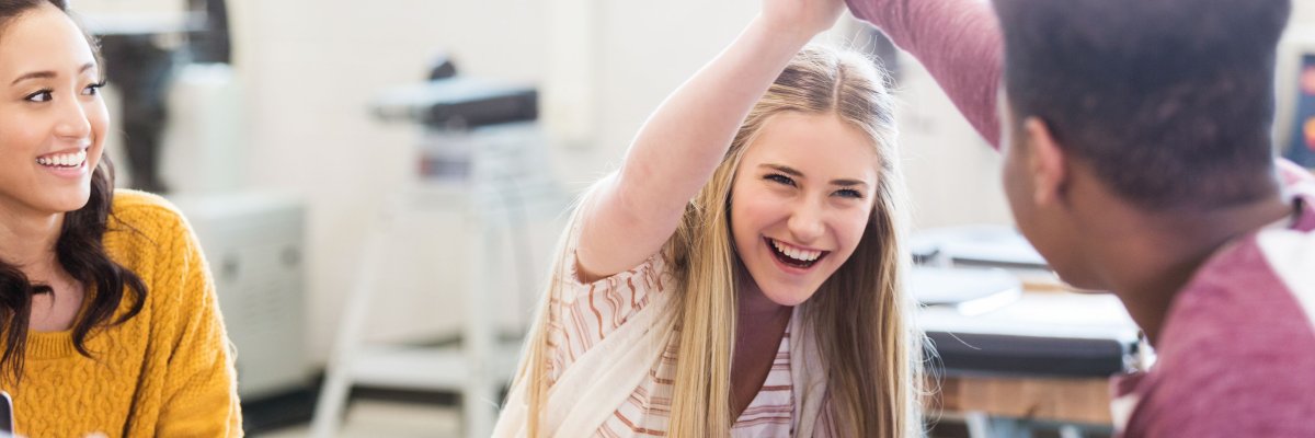Schüler im Klassenraum Schüler im Klassenraum geben sich Handschlag