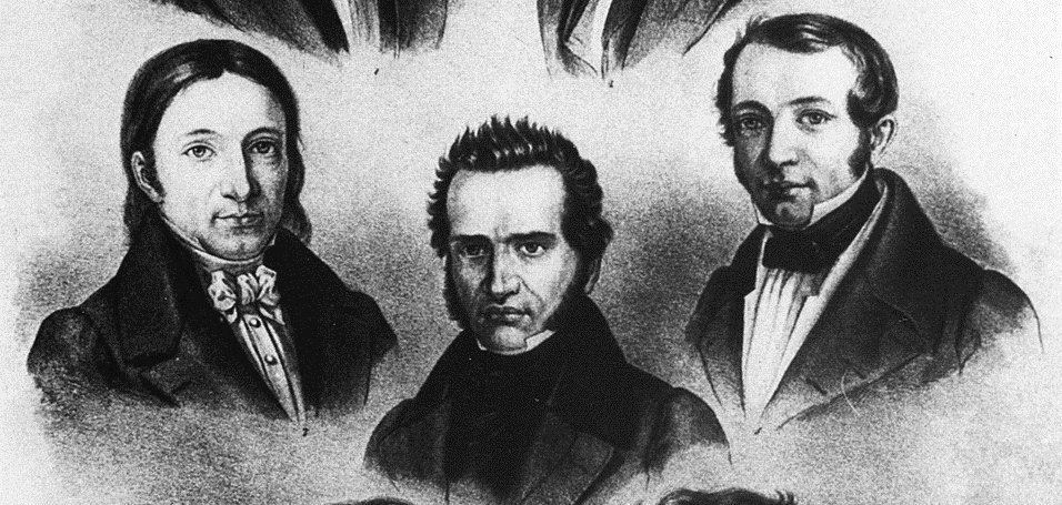 20260722_fap_2_bild.jpg Das Bild zeigt eine historische Schwarz-Weiß-Lithografie mit den Porträts von sieben Männern, die in drei Reihen angeordnet sind. Sie tragen die für das frühe 19. Jahrhundert typische Kleidung mit dunklen Mänteln, hohen Kragen und Halstüchern. Die Personen blicken jeweils in unterschiedliche Richtungen und sind als Brustbilder dargestellt. Unter den Porträts befinden sich handschriftliche Namensangaben. Die Darstellung vermittelt den Eindruck einer Sammlung bedeutender Persönlichkeiten oder Gelehrter aus dieser Epoche.
